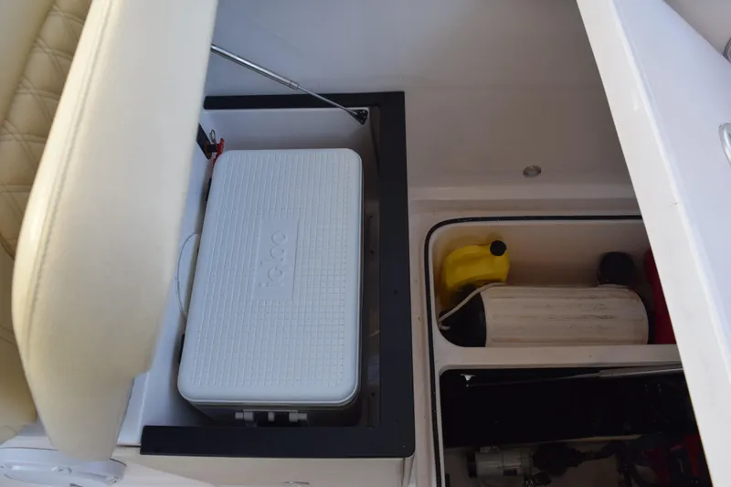 Slide: The Image of Storage compartment in 2021 Regal 26 XO boat with cooler and supplies. - 189