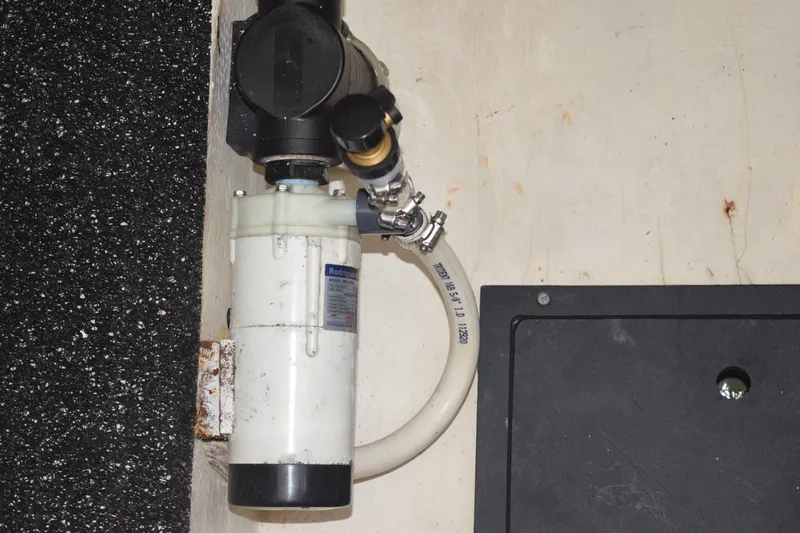 Slide: The Image of Boat engine component in a 2021 Regal 26 XO, featuring a filter and hose connection. - 193