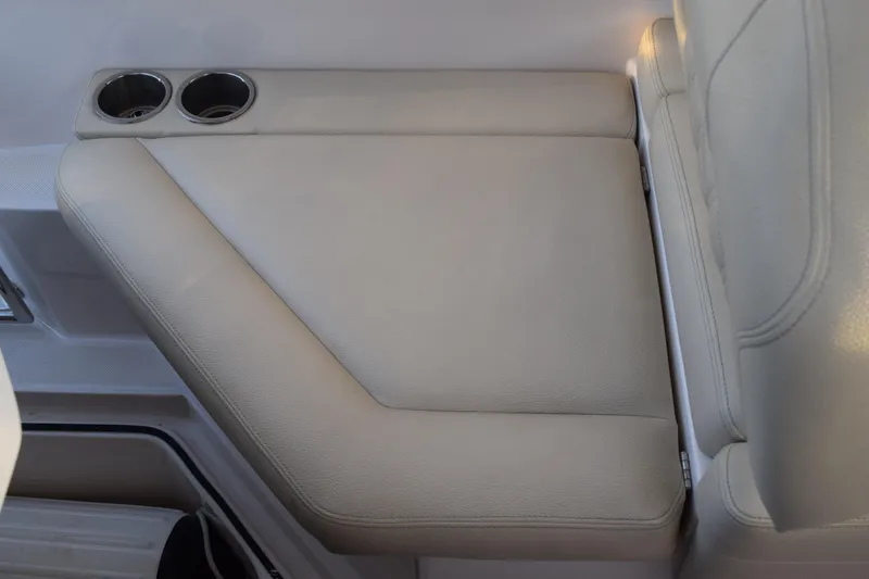 Slide: The Image of 2021 Regal 26 XO boat interior with beige seating and dual cup holders. - 194