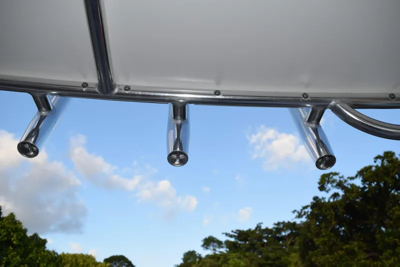 Slide: The Image of Rod holders on a 2021 Regal 26 XO boat against a blue sky backdrop. - 202