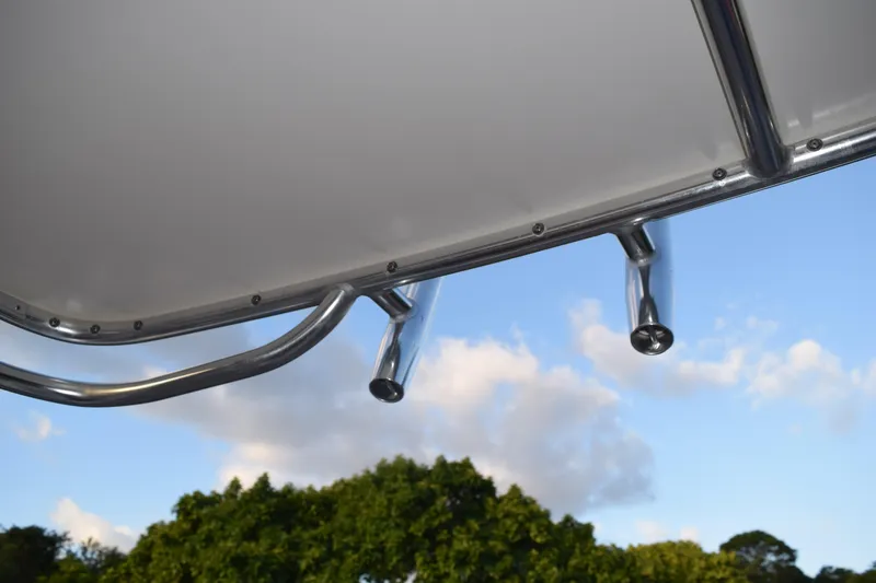 Slide: The Image of Stainless steel rod holders on a 2021 Regal 26 XO boat against a blue sky. - 203
