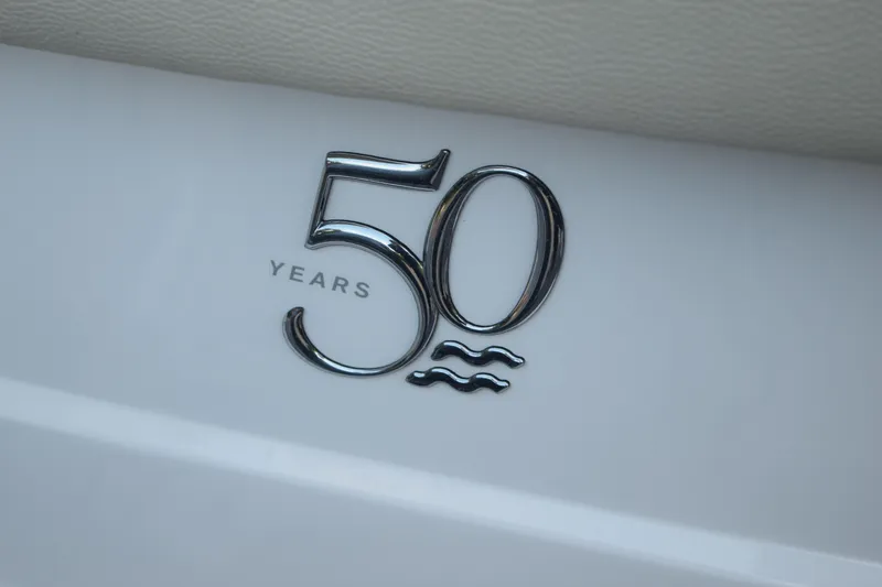 Slide: The Image of 50th anniversary emblem on 2021 Regal 26 XO boat. - 207