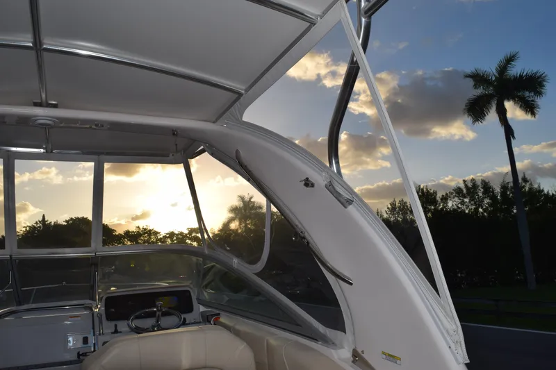 Slide: The Image of 2021 Regal 26 XO boat interior at sunset with palm trees in the background. - 214