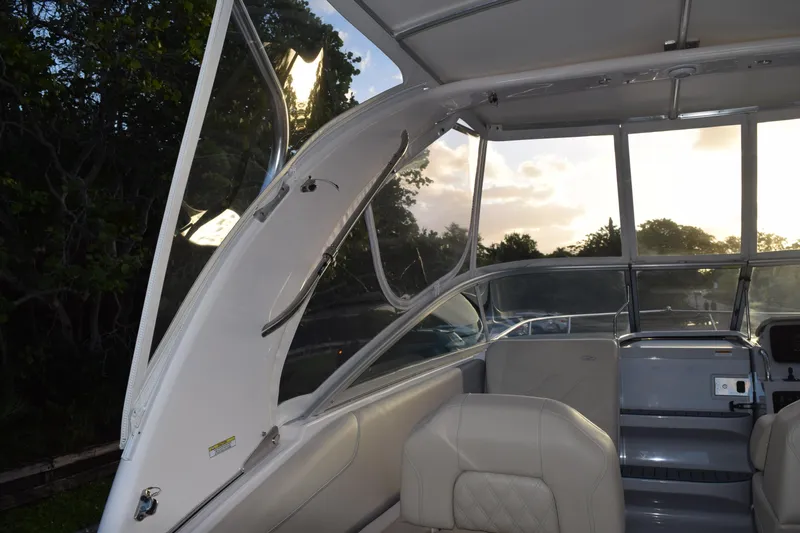 Slide: The Image of 2021 Regal 26 XO boat interior with seating and canopy at sunset. - 216
