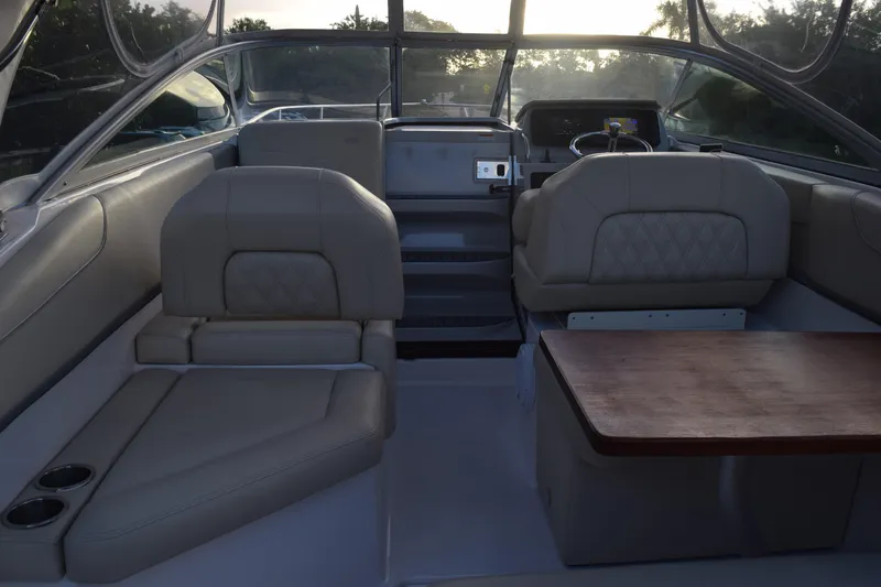 Slide: The Image of Interior of 2021 Regal 26 XO boat with seating and wooden table. - 217