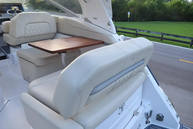 Slide: The Image of 2021 Regal 26 XO boat interior with beige seating and wooden table. - 219