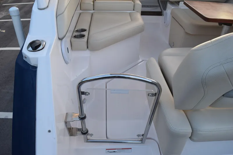 Slide: The Image of 2021 Regal 26 XO boat interior with beige seating and stainless steel railing. - 222