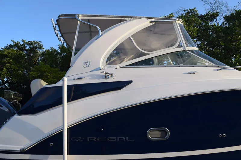 Slide: The Image of 2021 Regal 26 XO boat with sleek design, featuring a blue and white exterior. - 226