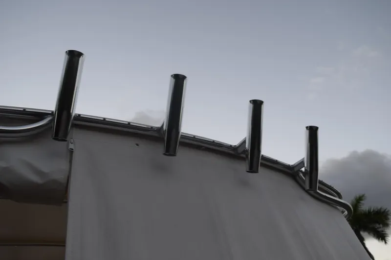 Slide: The Image of Rod holders on a 2021 Regal 26 XO boat against a cloudy sky. - 23