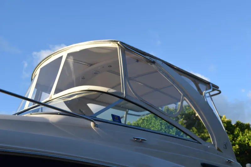 Slide: The Image of 2021 Regal 26 XO boat with sleek design against a clear blue sky. - 235