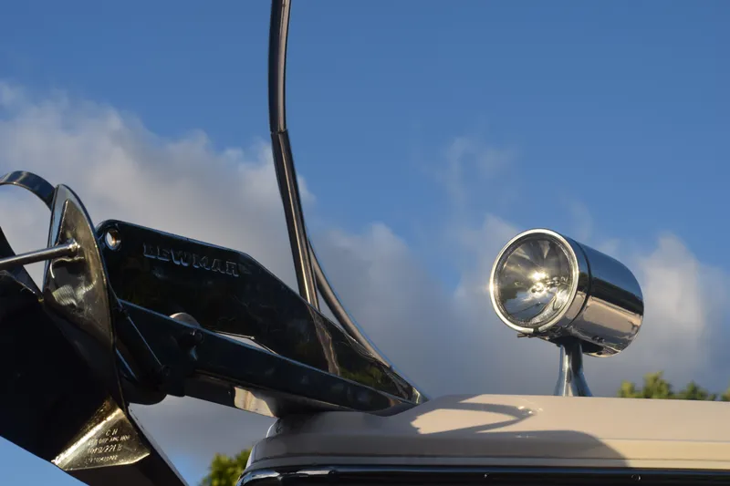 Slide: The Image of Close-up of 2021 Regal 26 XO boat spotlight and anchor against blue sky. - 241