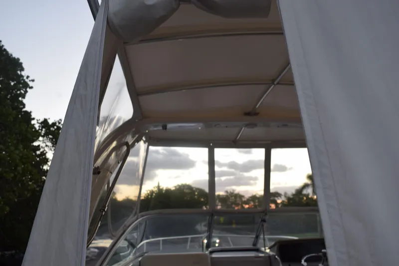 Slide: The Image of 2021 Regal 26 XO boat interior with canopy at sunset. - 26
