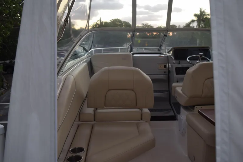Slide: The Image of Interior of 2021 Regal 26 XO boat with beige seating and steering area. - 27