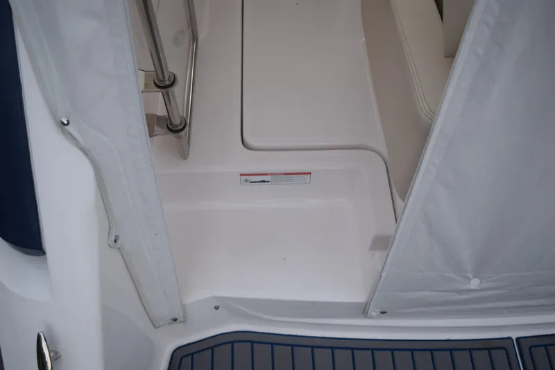 Slide: The Image of 2021 Regal 26 XO boat interior with white seating and flooring details. - 29