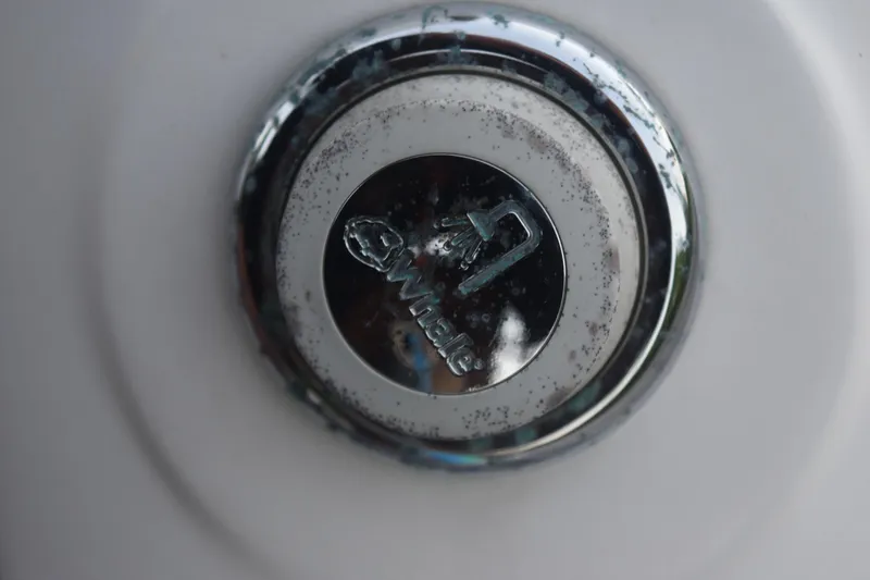 Slide: The Image of Close-up of a chrome drain plug on a 2021 Regal 26 XO boat. - 36
