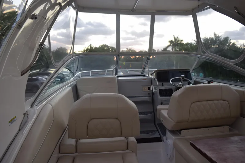 Slide: The Image of 2021 Regal 26 XO boat interior with beige seating and modern dashboard. - 42