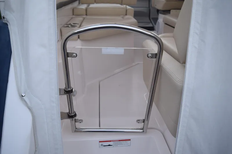 Slide: The Image of Interior view of 2021 Regal 26 XO boat with stainless steel gate and beige seating. - 43