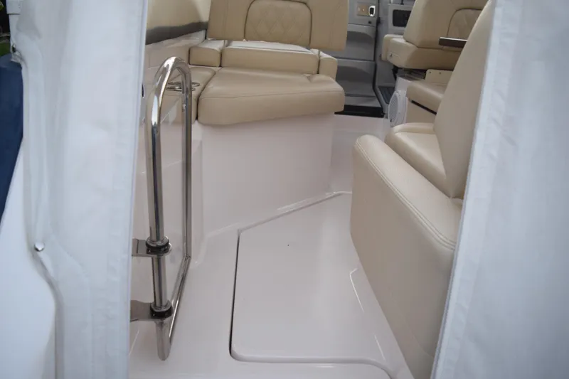 Slide: The Image of 2021 Regal 26 XO boat interior with beige seating and stainless steel railing. - 45