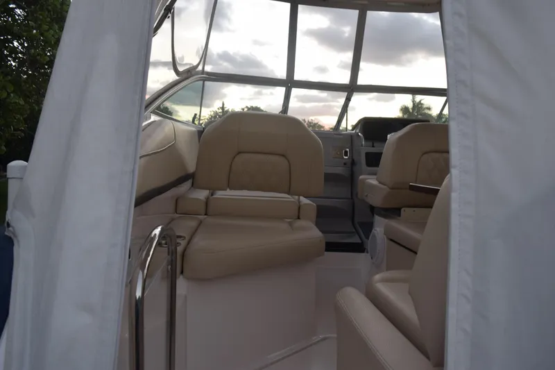 Slide: The Image of 2021 Regal 26 XO boat interior with beige seating and panoramic windows. - 46