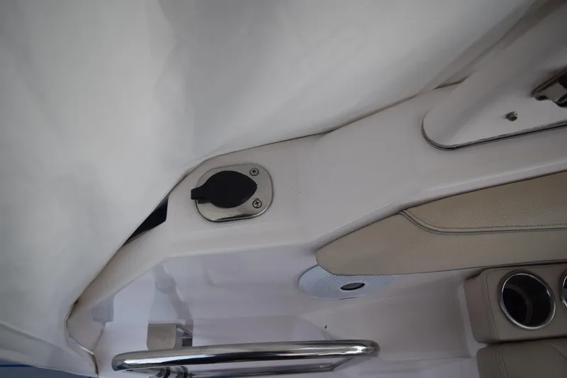 Slide: The Image of 2021 Regal 26 XO boat interior detail with cup holders and control panel. - 47