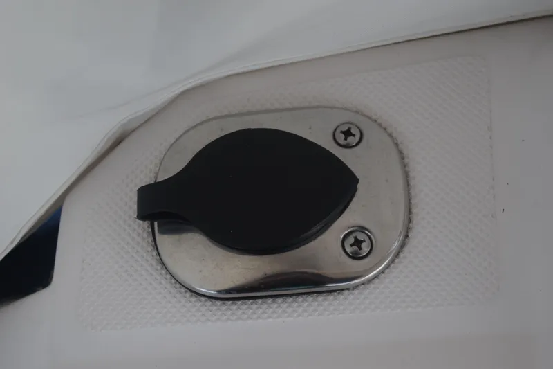 Slide: The Image of Close-up of a 2021 Regal 26 XO boat component with a black handle and screws. - 48