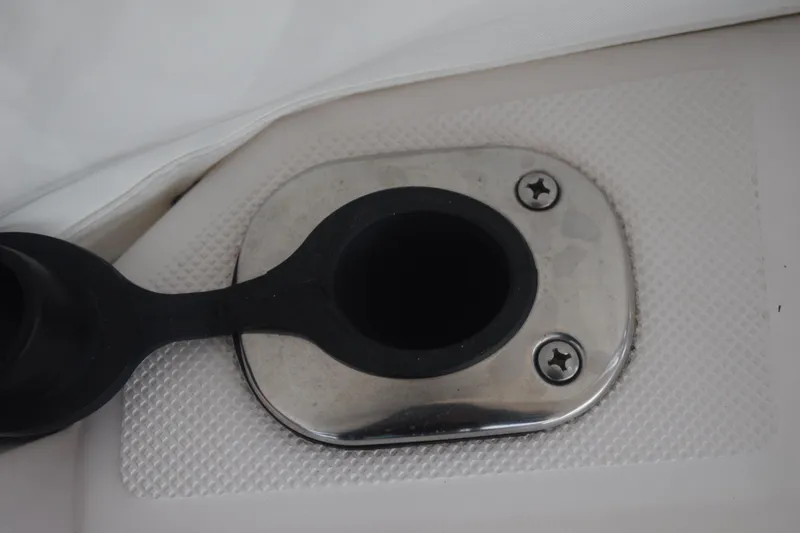 Slide: The Image of Fuel cap of a 2021 Regal 26 XO boat, featuring a stainless steel finish. - 49