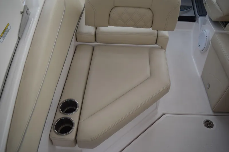 Slide: The Image of 2021 Regal 26 XO boat interior with beige seating and cup holders. - 50