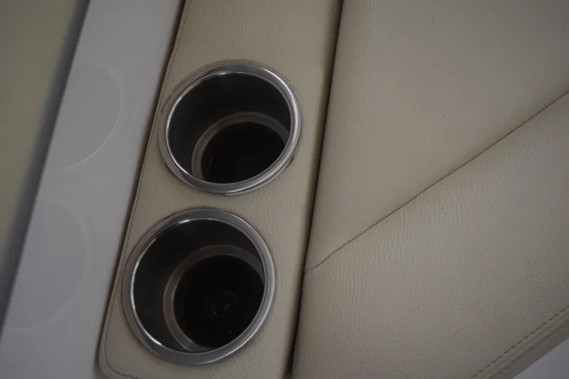 Slide: The Image of Cup holders on beige leather interior of 2021 Regal 26 XO boat. - 51