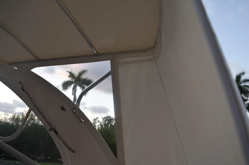 Slide: The Image of 2021 Regal 26 XO boat interior with palm trees in the background. - 54