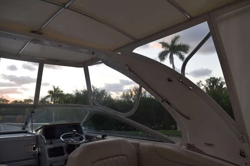 Slide: The Image of Interior view of 2021 Regal 26 XO boat with palm trees and sunset in background. - 55