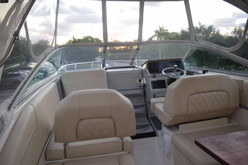 Slide: The Image of Interior of a 2021 Regal 26 XO boat with beige seating and steering area. - 57