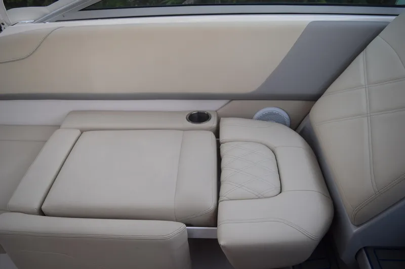 Slide: The Image of 2021 Regal 26 XO boat interior with beige leather seating and cup holder. - 63