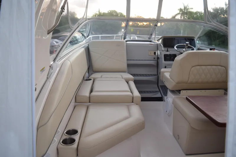 Slide: The Image of 2021 Regal 26 XO boat interior with beige seating and steering area. - 64