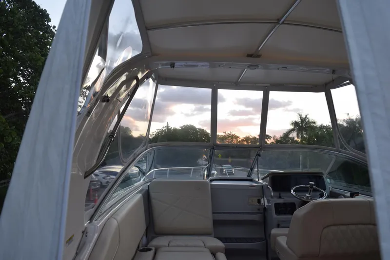 Slide: The Image of Interior view of 2021 Regal 26 XO boat at sunset, featuring helm and seating. - 65