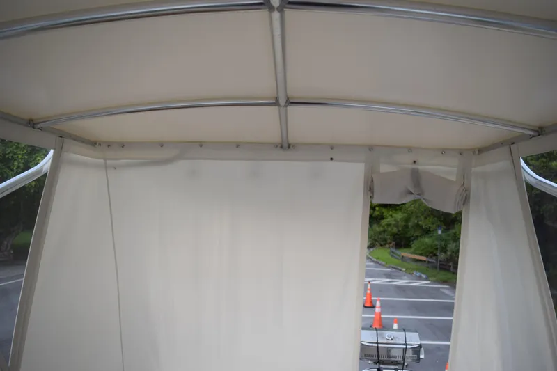 Slide: The Image of Interior view of 2021 Regal 26 XO boat canopy with road and traffic cones visible outside. - 67