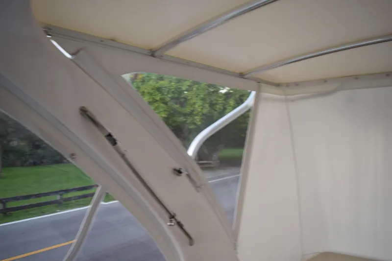 Slide: The Image of 2021 Regal 26 XO boat interior with canopy and road view. - 68
