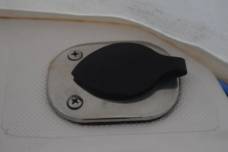Slide: The Image of Fuel cap on 2021 Regal 26 XO boat, featuring a black cover and stainless steel base. - 74