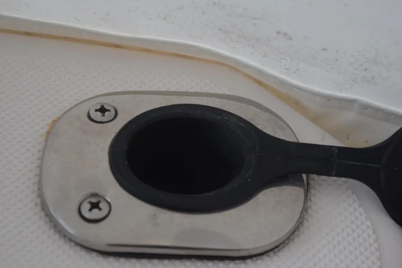 Slide: The Image of Boat deck drain plug on 2021 Regal 26 XO, featuring stainless steel and rubber components. - 75