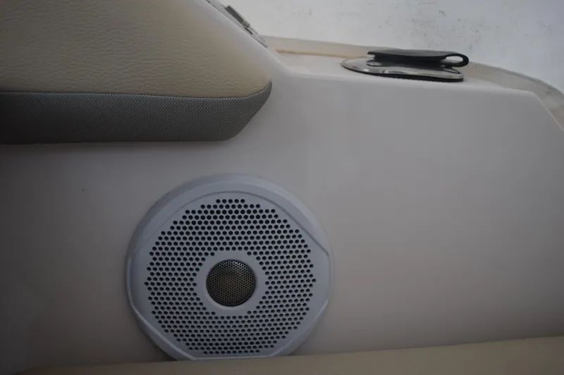 Slide: The Image of 2021 Regal 26 XO boat interior with speaker and beige upholstery. - 76
