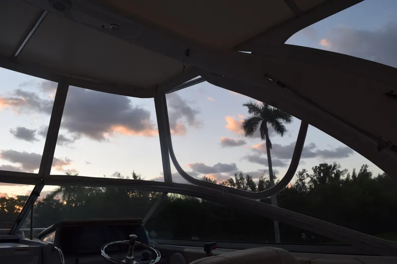 Slide: The Image of Interior view of 2021 Regal 26 XO boat at sunset with palm trees. - 79