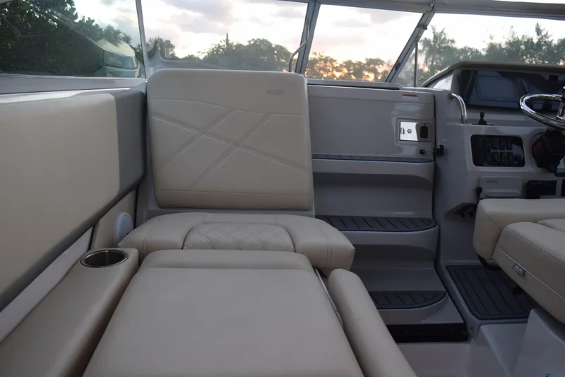 Slide: The Image of 2021 Regal 26 XO boat interior with beige seating and helm, showcasing luxury design. - 81