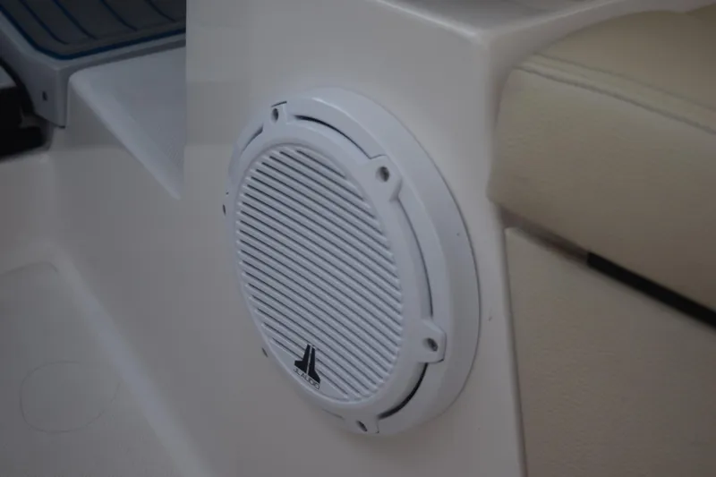 Slide: The Image of White speaker on 2021 Regal 26 XO boat interior, near beige seating. - 82