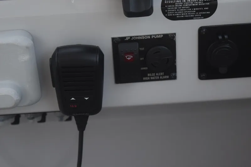 Slide: The Image of Control panel of a 2021 Regal 26 XO boat with Garmin device and Johnson pump. - 88