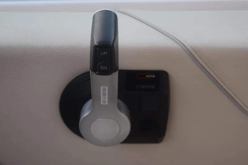 Slide: The Image of Throttle control lever on a 2021 Regal 26 XO boat dashboard. - 90