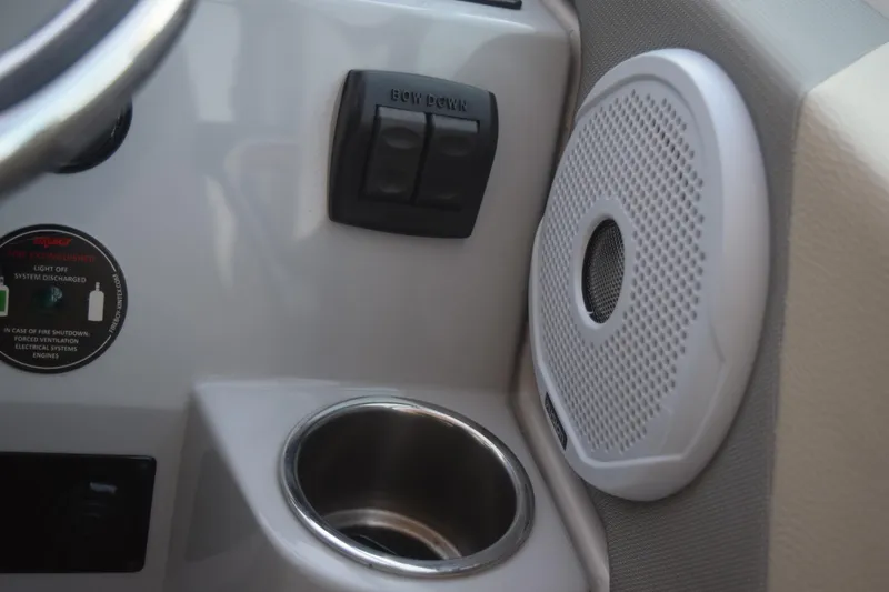 Slide: The Image of Interior of 2021 Regal 26 XO boat with speaker, cup holder, and control panel. - 92