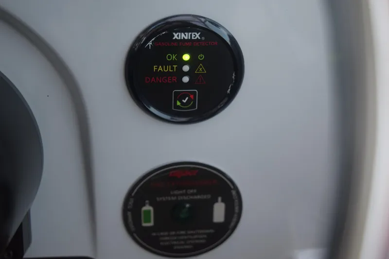 Slide: The Image of Gasoline fume detector on 2021 Regal 26 XO boat dashboard, indicating status lights. - 93