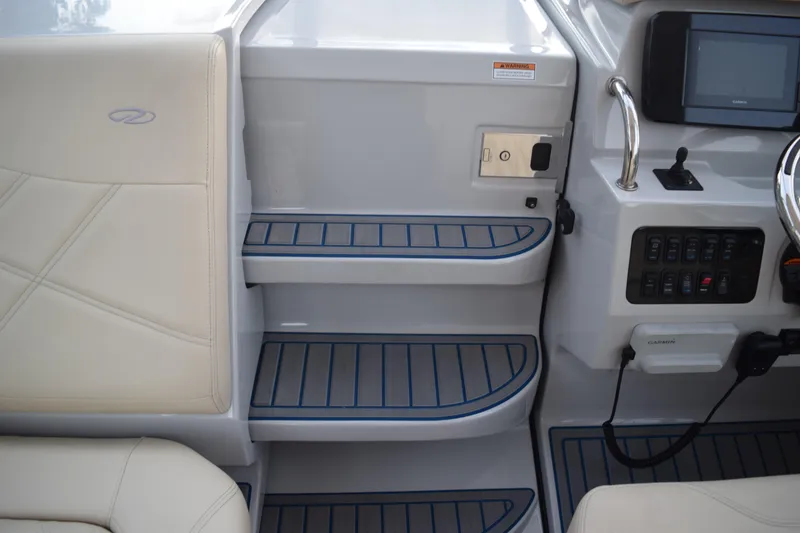 Slide: The Image of Interior view of 2021 Regal 26 XO boat, featuring steps and control panel. - 96