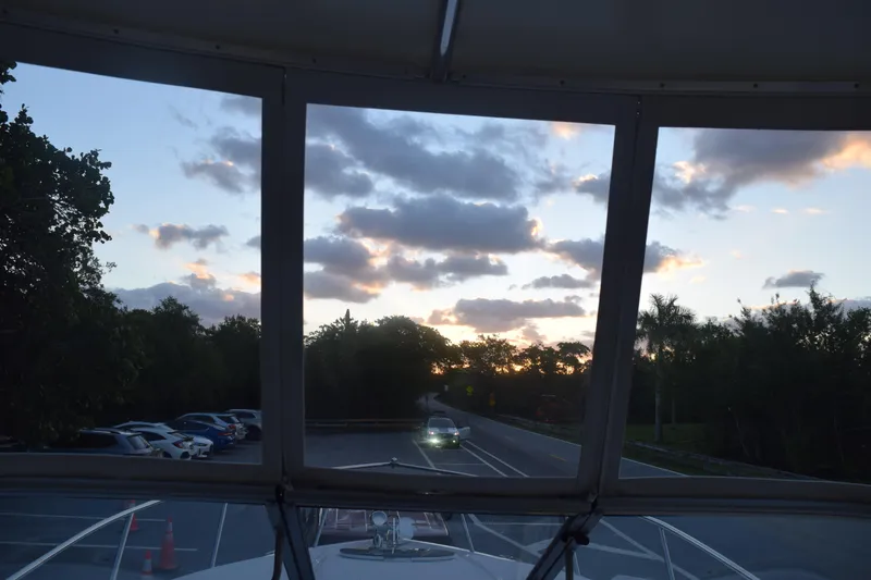 Slide: The Image of Sunset view from a 2021 Regal 26 XO boat on a road with parked cars. - 98