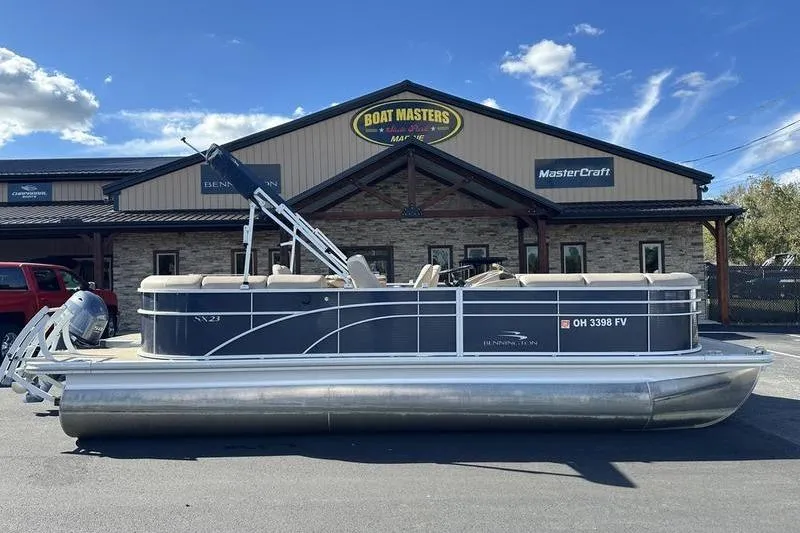 Slide: The Image of 2014 Bennington 24 SPDX pontoon boat parked outside Boat Masters Marine dealership. - 2