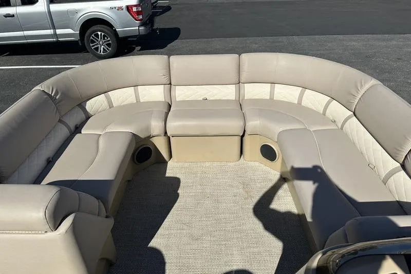 Slide: The Image of 2014 Bennington 24 SPDX boat interior with beige seating and carpeted floor. - 22